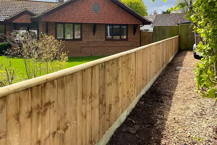Wooden garden fencing in Gloucester with a simple and clean design along a backyard.